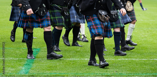 Scottish kilt parade on green field