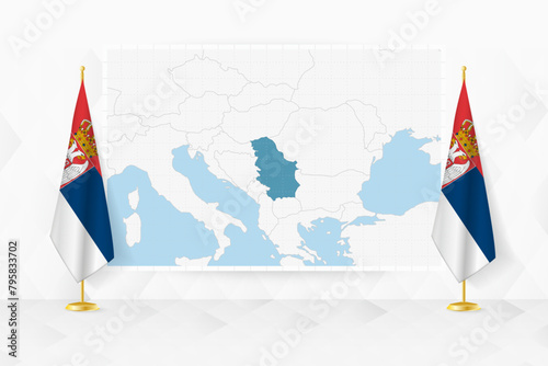 Map of Serbia and flags of Serbia on flag stand.