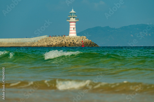 Red lighthouse in the sea.