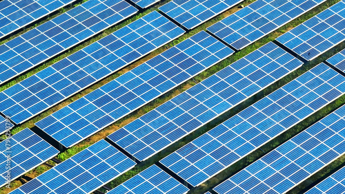 A solar farm is a vast expanse of solar panels harnessing sunlight to generate electricity. These clean energy installations help reduce carbon emissions and provide sustainable power. Aerial view. 