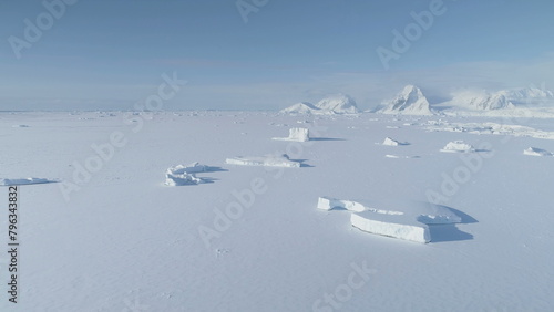 Antarctica Iceberg Locked in Ice Aerial View. Arctic Polar Frozen Ocean Covered with Snow. Expedition to North Nature Landscape Coastline Glacier..