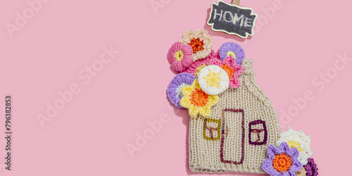 Handmade home spring decor concept. Creative crocheting, house figurine, traditional flowers