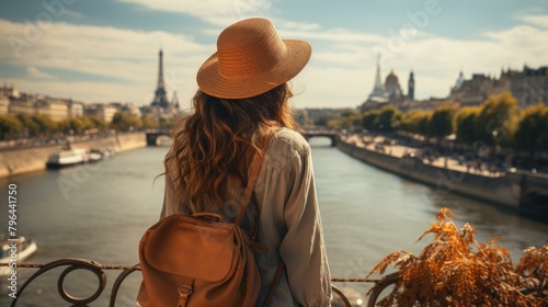 b'Young woman admiring the view of Paris from a bridge'