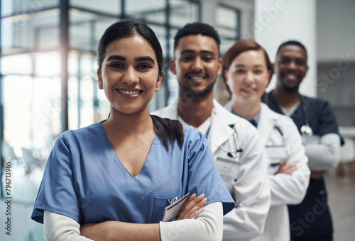 Doctors, woman and arms crossed with smile, team or portrait for diversity in medical career at hospital. Surgeon group, people and men with collaboration, wellness and pride for healthcare services