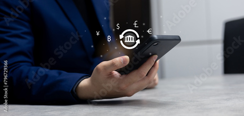 close up investor man hand holding smartphone and trade global currency exchange market by use money transfer application transaction on web for financial and technology with modern lifestyle concept 