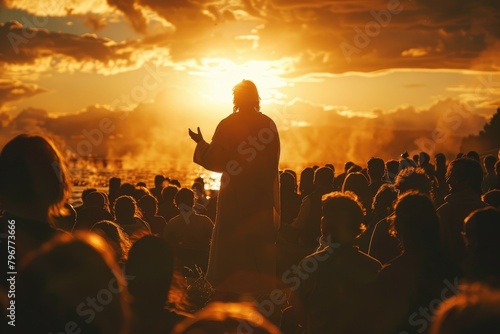 Rear shot of Jesus at The Sermon on the Mount, the setting sun creating a silhouette as He speaks to an absorbed crowd,