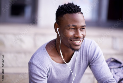 Outdoor, earphones and black man in campus, smile and listening to audio, radio and music in morning. Academy, student and university for person, education and knowledge in Atlanta, city and relax