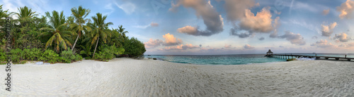 Maldivian panoramic sunset with ocean cost and palms