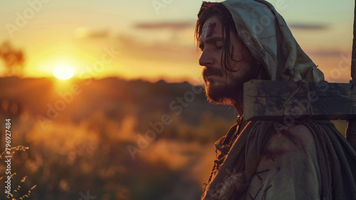 Man in hooded cloak at sunset