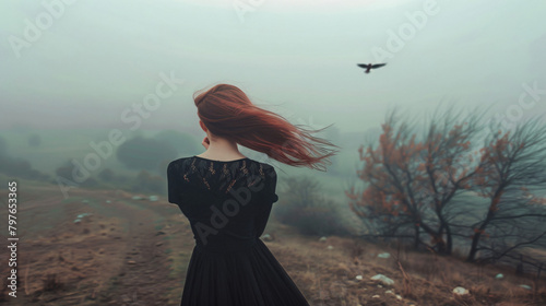 A sad lady in a black dress unhappy wanders in the fog