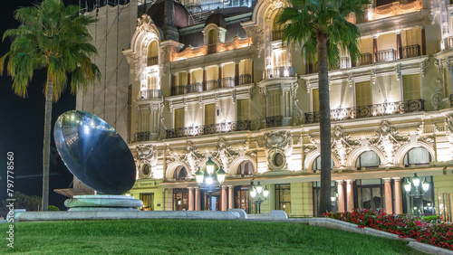 Casino square with palms and fountain at night timelapse in Monte Carlo in Monaco.