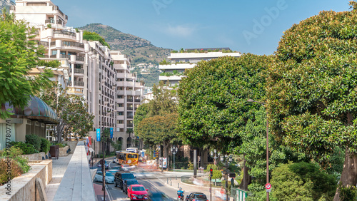 Traffic on a street near water fountain and gardens timelapse near Monte-Carlo Casino.