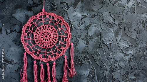 Pink ash crochet doily dream catcher close up on dark gray textured background ,Gray blue lace dream catcher on black textured background
