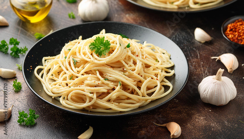 Close-up of spaghetti aglio e olio with sauteed garlic, chili flakes, parsley. Tasty Italian food.