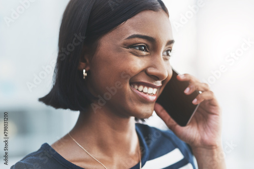 Business woman, phone call and networking in an office with administration and company talk. Smile, mobile and conversation of a startup employee and professional with listening in a creative agency