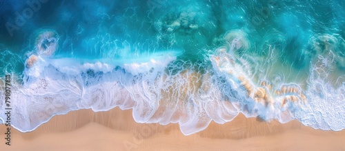 Ocean waves roll onto sandy beach, captured in panoramic aerial view with space for text