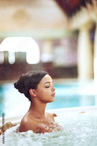 Woman, hot tub and relax calm at spa hotel for stress relief treatment or hydrotherapy, resort or hospitality. Female person, jacuzzi and lodge accommodation in Miami or hygiene, resting or travel