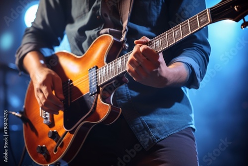 b'Close-up of a musician playing the guitar on stage'