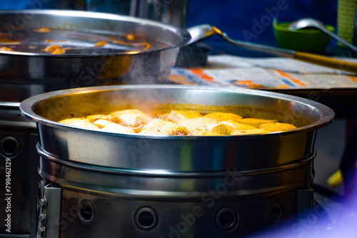 a street food stall where freshly prepared spicy stinky tofu is on display
