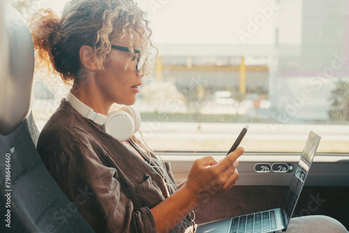 Businesswoman traveling on bus transport service transfer and writing message on mobile phone. One modern woman reading notification on cellphone sitting inside a bus vehicle. Travel and job lifestyle