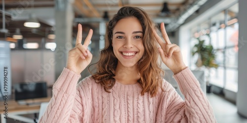 Peaceful, joyful, and motivated businesswoman with sign in workplace. Hispanic woman, girl, or hand gesture for solidarity, amusing or goofy for break, smiling and joyous with grin