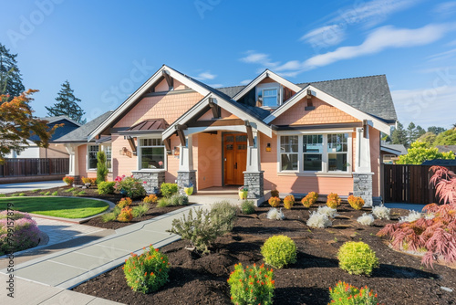 A newly constructed soft peach craftsman cottage style home, showcasing a triple pitched roof, thoughtful landscaping, a direct pathway