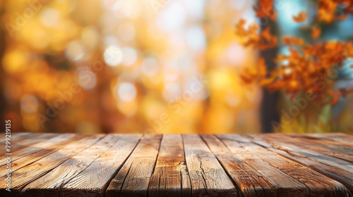 Wooden surface with a vibrant autumnal bokeh background, perfect for seasonal displays and themes