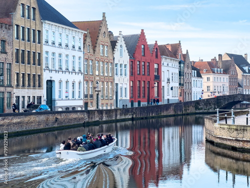 Tourist boat on canal in Bruges in a beautiful summer day, Belgium