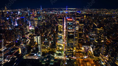 Night scenery of New York, the USA with fantastic illumination. Skyscrapers in the scenery of metropolis are dazzling and sparkling with lights. Top view.