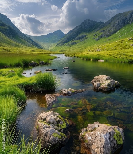 Beautiful mountain valley landscape with river flowing through green fields