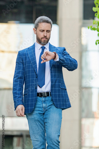 Punctual businessman checking time outdoor. Business deadline. Businessman late for business deadline. Time management. Punctual man check time on watch being late. Businessman with watch