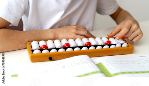 boy doing mental arithmetic on abacus