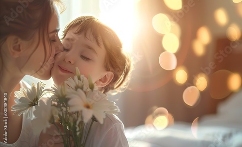 Closeup of a happy mother's day child son Surprise gives flowers for mother on holiday and kisses a mother with a blurred or bokeh background of bedroom 