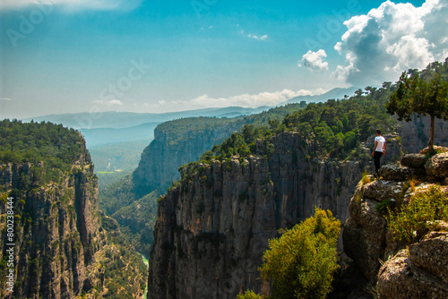 Magnificent view of Tazi Canyon in Koprulu Nature Park in Turkey and man standing on top of majestic cliff. View of the valley from above. Manavgat, Antalya.