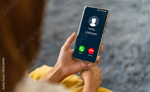 Human use smartphone with incoming call from unknown number, spam, prank caller, hoax person, fake identity, scammer, scam with mobile phone, hacker, call center, crime, call, fraud or phishing