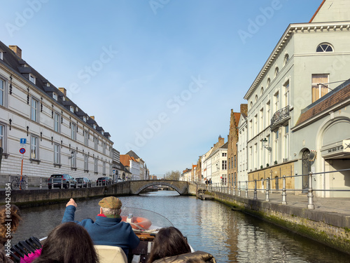 Tourist boat on canal in Bruges in a beautiful summer day, Belgium