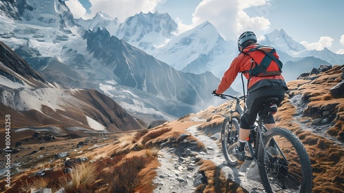 Mountain biking towards snowy peaks