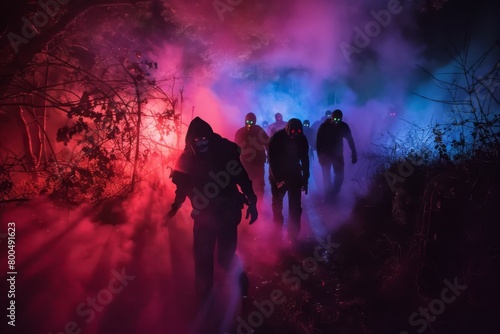 The image depicts a thrilling and suspenseful scene from a Halloween haunted maze event A group of darkened figures perhaps actors dressed as ghouls or monsters can be seen emerging from the thick