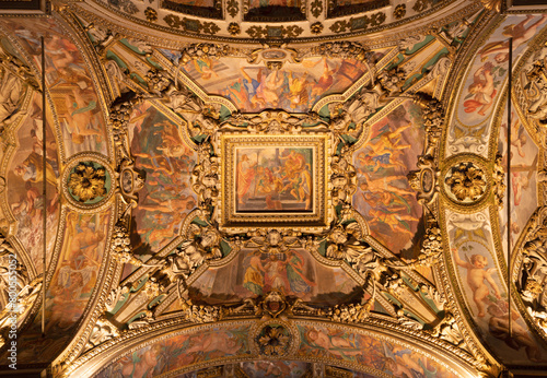 MILAN, ITALY - MARCH 5, 2024: The baroque ceiling with the frescoes from Live of early-christian martyr in the side nave of church Chiesa di San Vittore al Corpo. 