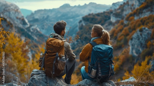 A couple discussing their life insurance options while enjoying a scenic outdoor hike, incorporating financial planning into their active lifestyle.