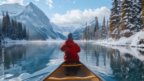 Rear view a male traveler drive a canoe in deep lake in winter season. Generated AI image
