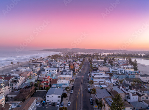 Aerial view of colorful sunrise sky over Mission Beach San Diego with residential vacation homes, villas with nobody on the street