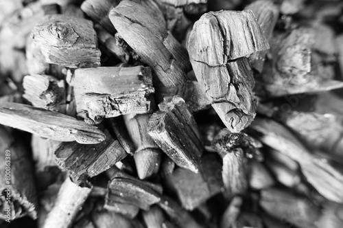 Black and white abstract zoom shot of dry burnt wood on a campfire
