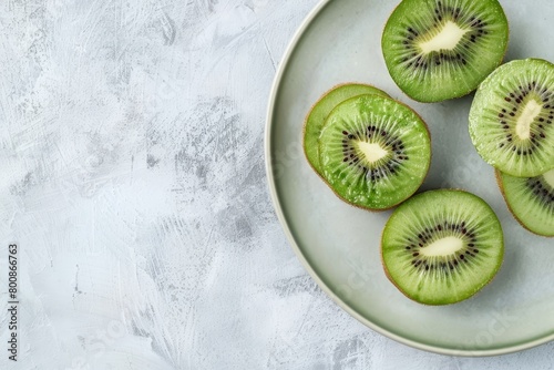 Fresh kiwi slices on a white plate