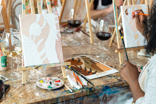 Painting and sip workshop. Woman enjoying art and wine.