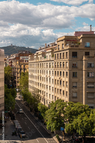 View of Urban Barcelona with Historical Buildings and Tree-Lined Streets
