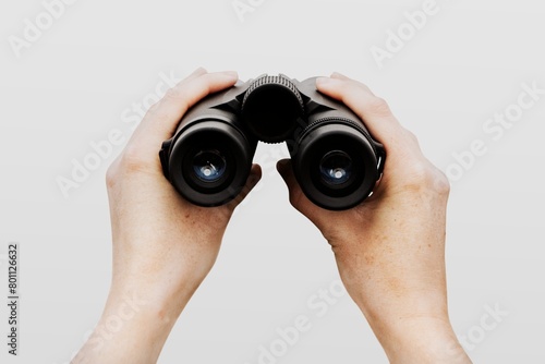 Spy holding binoculars, isolated on white