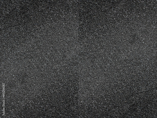 black sponge foam material surface background. textured absorbent material and soft pores 