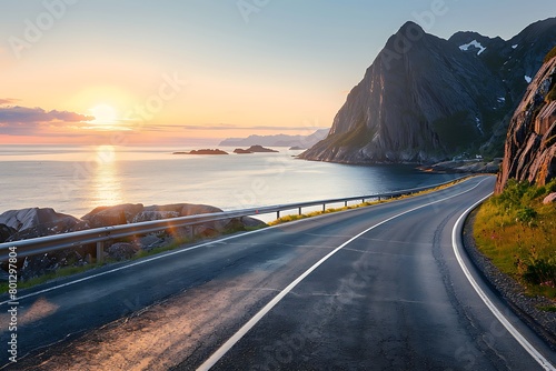 A coastal road in Norway, with the sea on one side and cliffs to another, bathed by the golden sunset light