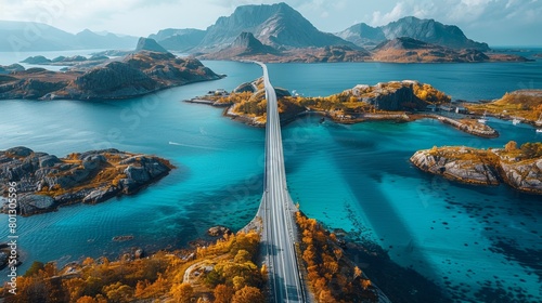 Aerial image features the majestic Saltstraumen Bridge in Norway, gracefully arching over turquoise waters, framed by vibrant autumn foliage and rugged mountains.